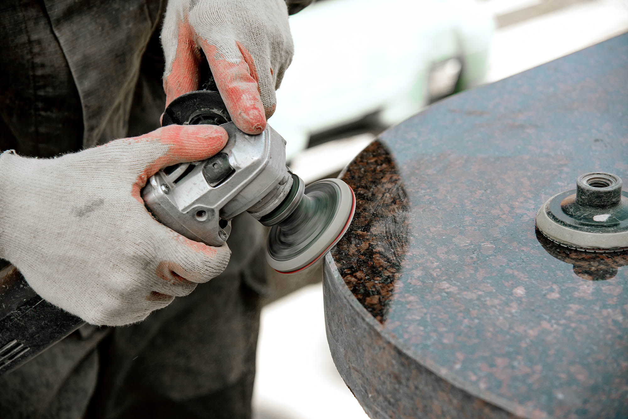 A,man,works,polishing,a,marble,stone,with,an,angle