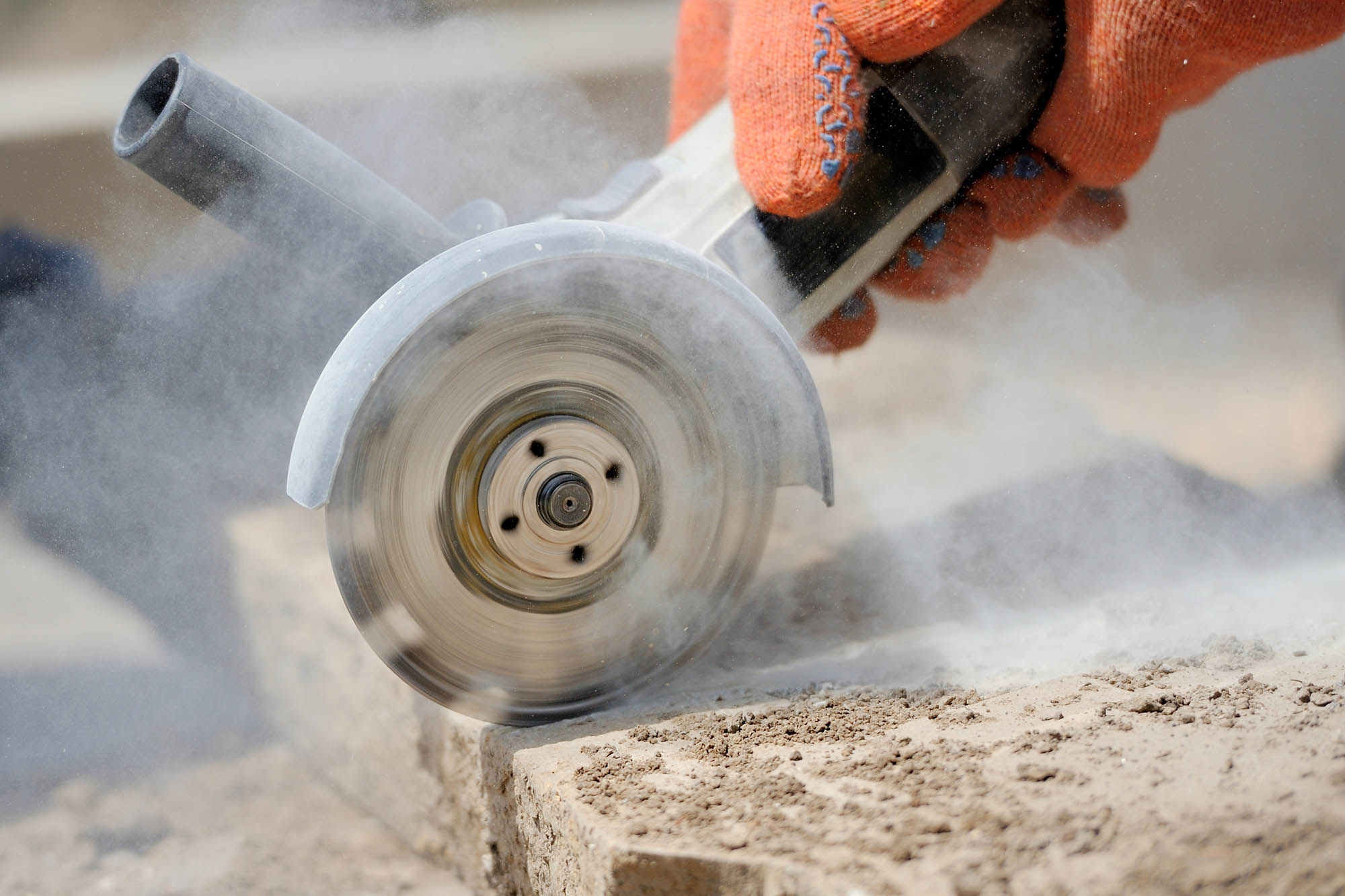 Grinder worker cuts a stone